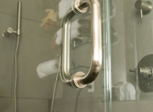 Glass shower door with stainless steel handle